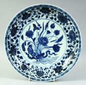 A CHINESE BLUE AND WHITE PORCELAIN PLATE, the centre with floral spray and lotus, further