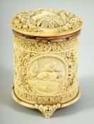 A FINE RARE 18TH CENTURY SRI LANKAN CARVED IVORY CYLINDRICAL BOX, with hinged cover depicting a
