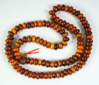 A HORN NECKLACE, weighing 89.1gm, composed of flattened circular beads, approx. 31in long.