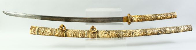 A GOOD JAPANESE SECTIONAL BONE OR IVORY TACHI, carved all over with seated figures, 114cm long.