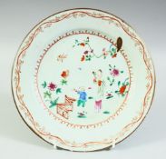 A CHINESE FAMILLE ROSE PORCELAIN PLATE, painted with a female figure and child, 22.5cm diameter.