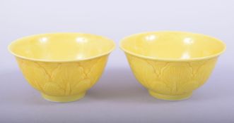 A PAIR OF CHINESE YELLOW GLAZED PORCELAIN CUPS, each with six character mark to base, 7.5cm