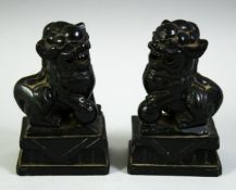 A PAIR OF 19TH CENTURY CHINESE CRAVED BLACK HARDSTONE FO DOGS, 10cm high.