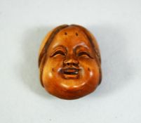 A SMALL CARVED WOOD NETSUKE, okame mask, 2.5cm.