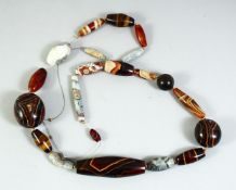A GOOD LARGE AGATE BEADED NECKLACE, comprising of 21 beads of various forms and sizes, largest