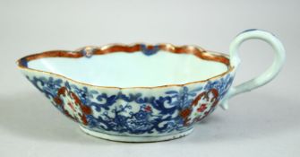 A CHINESE BLUE AND WHITE / FAMILLE ROSE PORCELAIN SAUCE BOAT, the interior painted with a garden