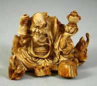 A JAPANESE CARVED IVORY OKIMONO, depicting a bearded figure surrounded by rats, 8cm wide.