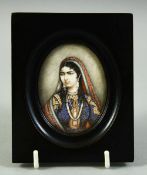 AN INDIAN MINIATURE OVAL PORTRAIT OF A FEMALE FIGURE on ivory, in an ebonised wood frame and glazed,
