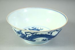 A GOOD CHINESE BLUE AND WHITE PORCELAIN BOWL, painted with dragons, the base with six character