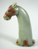 AN INDIAN GREEN HARDSTONE HORSE HEAD DAGGER HANDLE, onlaid with wirework and semi precious stones,