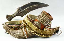 A MIDDLE EASTERN JAMBIYA DAGGER AND BELT, with wooden handle mounted with white metal, the wooden