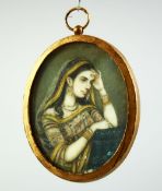 AN INDIAN MINIATURE OVAL PORTRAIT OF A FEMALE FIGURE on ivory, encased within a gilt metal frame and
