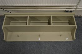 A painted hallway wall shelf / storage unit.