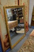 A large modern gilt framed mirror.