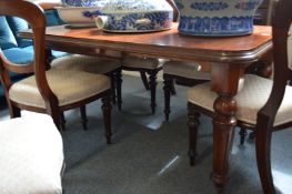 A Victorian and later extending mahogany dining table.