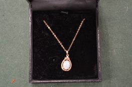 A gold and opal set pendant and chain.