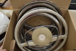 A Mercedes Pagoda steering wheel and wheel trims.