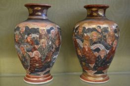 A pair of Satsuma vases decorated with numerous figures.
