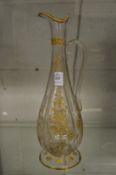 A gilt decorated engraved glass claret jug.