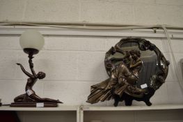 An Art Nouveau style figural lamp and similar mirror.