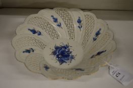 A small porcelain blue and white bowl with pierced decoration.
