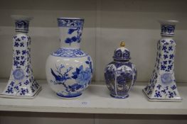 A Chinese blue and white vase and similar pair of candlesticks and a jar and cover.