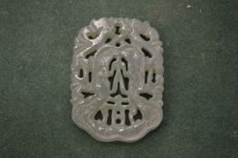 A carved jade amulet.