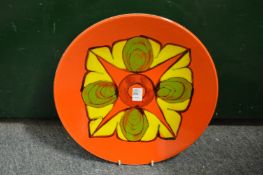 A Poole Pottery Delphis charger, orange ground with stylized floral decoration shape no. 5, 14ins