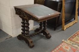 A Victorian oak desk with carved decoration.