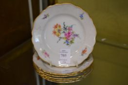 Six small Meissen circular plates painted with flowers.