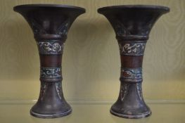 A pair of Japanese bronze Gu shaped vases with enamel decoration.