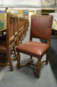 A set of ten oak dining chairs with leather cloth upholstered backs and seats, together with a
