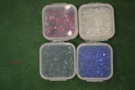 Four small boxes of spinels.