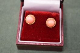 A pair of coral ear studs.