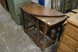 An old oak drop-leaf gate-leg table.