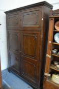 A large mahogany standing four-door cupboard.