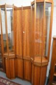 A unique walnut display cabinet on stand with four central doors flanked by octagonal shaped display