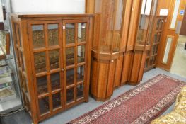A good pair of stained pine standing two door display cabinets.