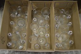 A large quantity of clear glass lampshades.