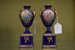 A pair of small Vienna porcelain pedestal vases.