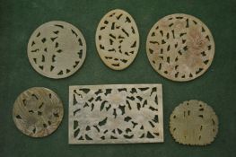 A collection of five Chinese carved jade and pierced amulets.