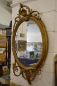 A 19th century decorative gilt framed oval girandole.