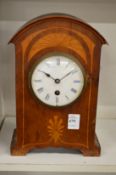 A mahogany mantle clock.