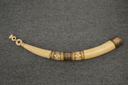 A carved ivory and silver plate mounted horn shaped vessel.