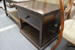 An oak single drawer two tier lamp table.