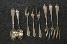 A small group of silver flatware.