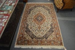 A Persian style rug, beige ground with floral decoration.