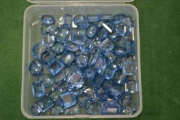 A box of aquamarine coloured stones.