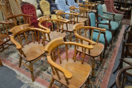 A set of eight modern beech spindle back smoker's bow style dining chairs.