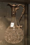 A cut glass claret jug with plated mount.